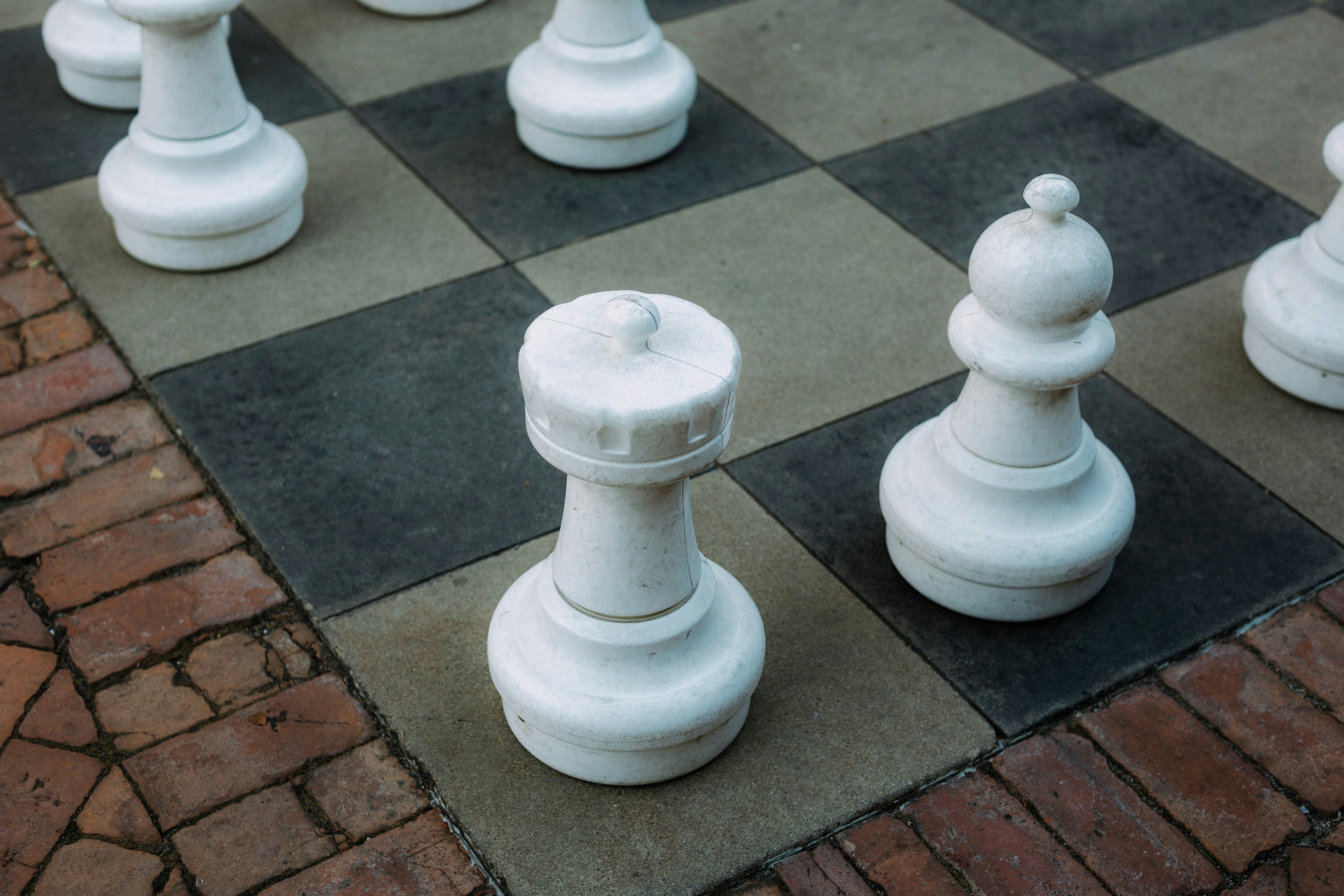 A group of white chess pieces sitting on top of a chess board