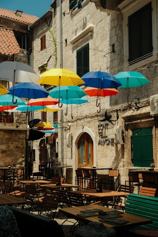 A bunch of umbrellas that are outside of a building