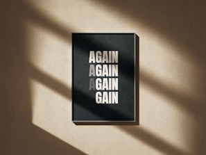 A black and white poster hanging on a wall