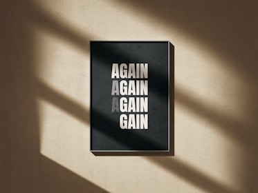 A black and white poster hanging on a wall
