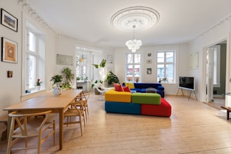 A living room filled with furniture and lots of windows