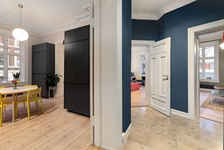 A living room with blue walls and white trim
