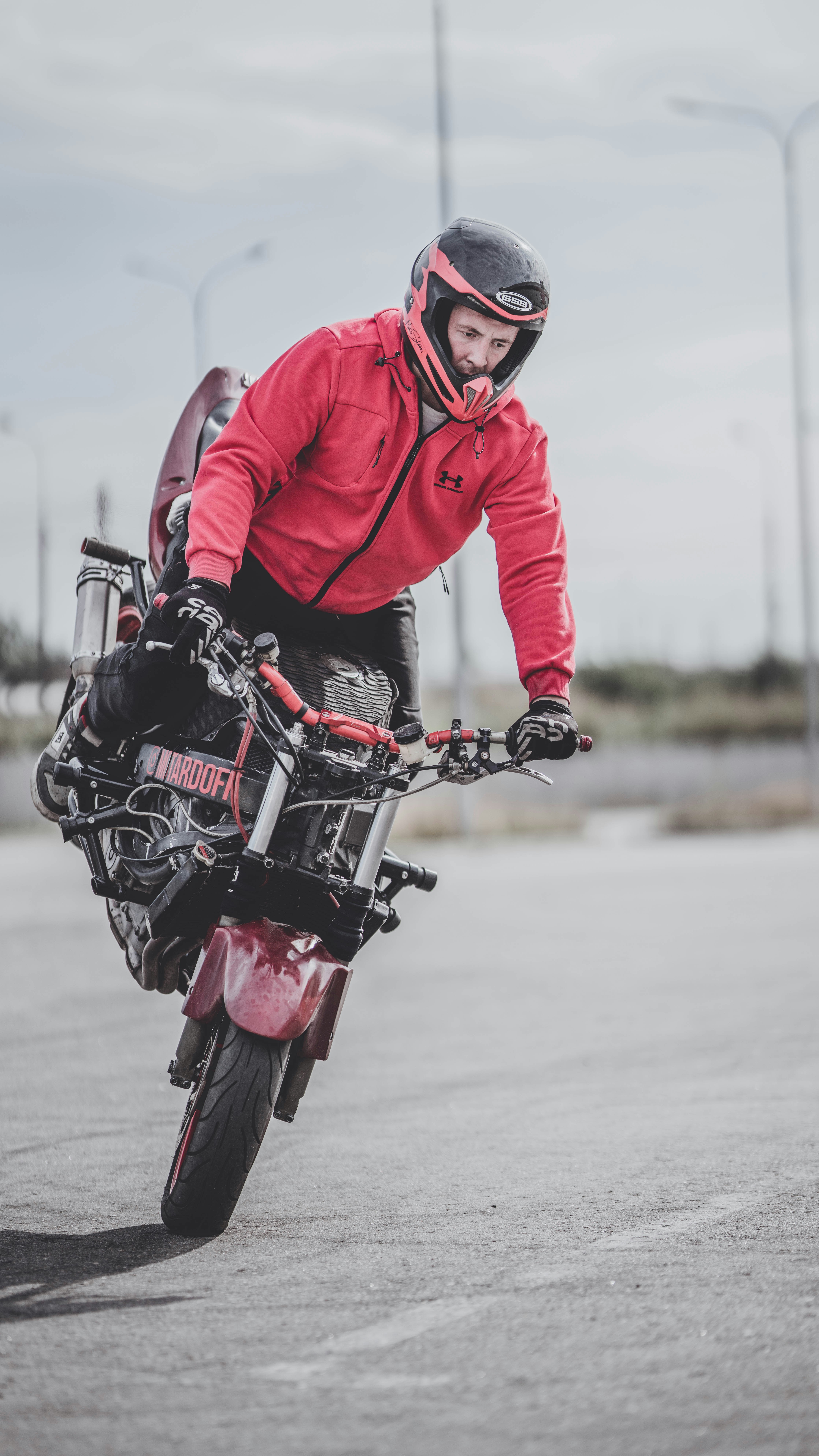 A man riding on the back of a motorcycle down a street