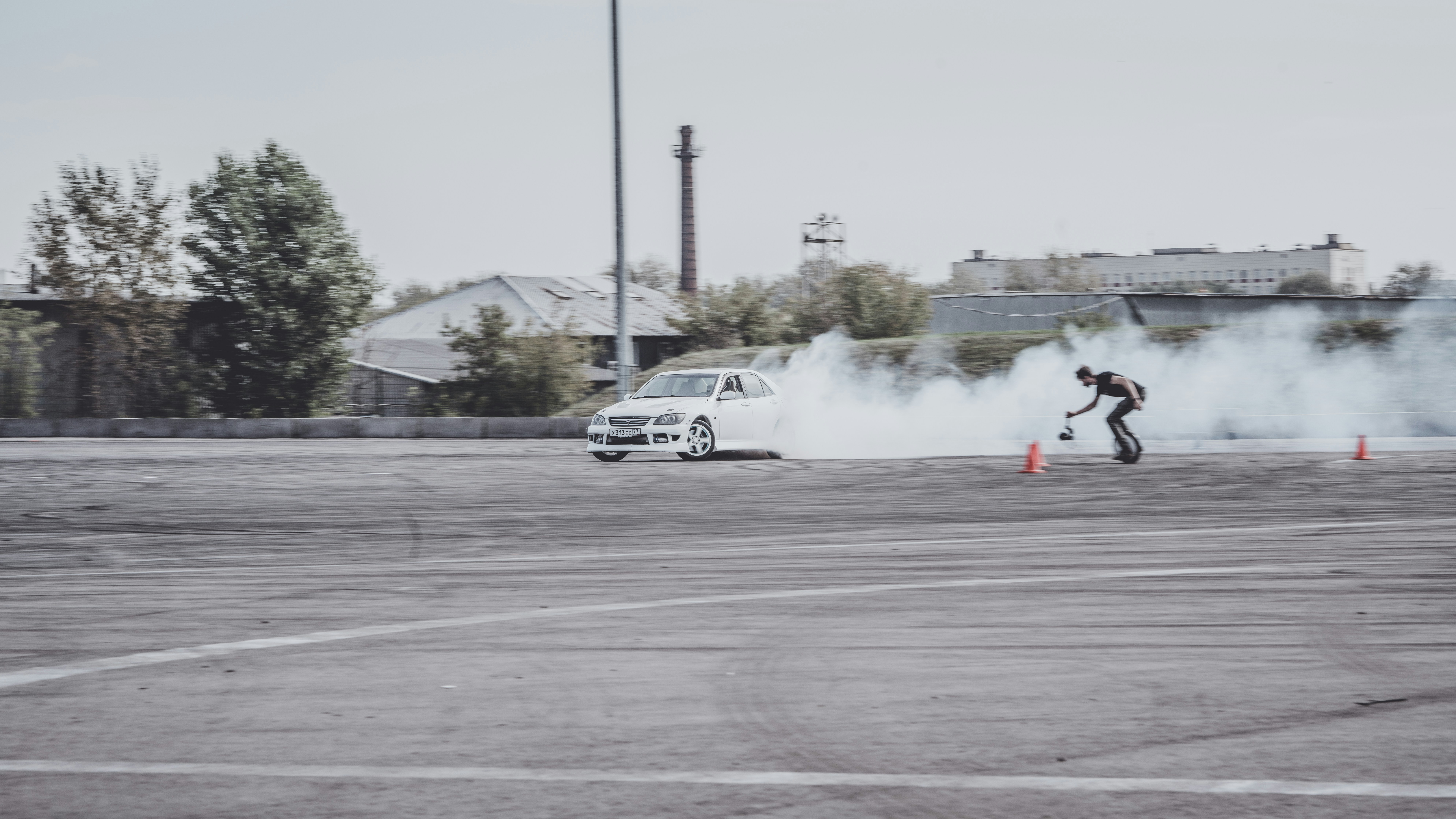 A person riding a skateboard on top of a parking lot
