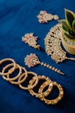 A bunch of jewelry laying on a blue surface