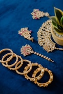 A bunch of jewelry laying on a blue surface