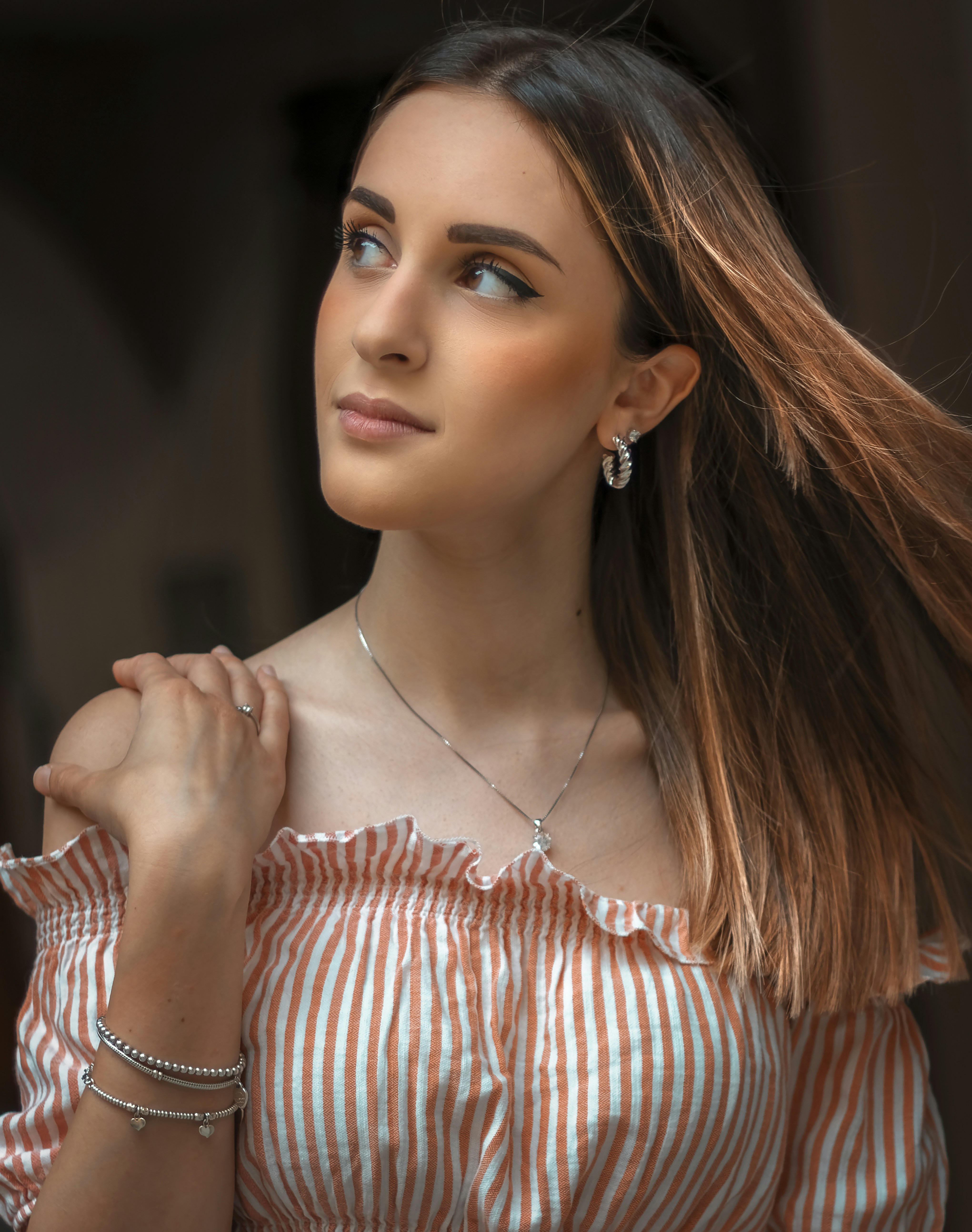 A woman with long hair wearing a striped shirt