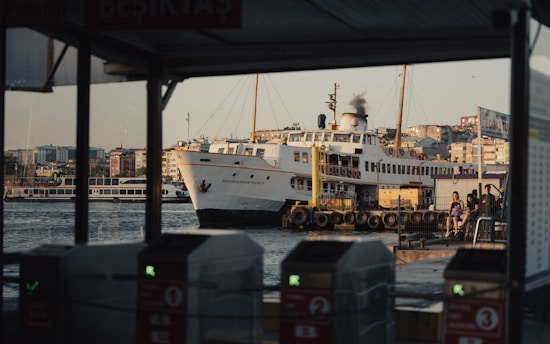 A large white boat in the water next to a dock