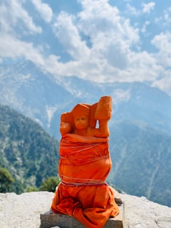 A statue of a person on top of a mountain