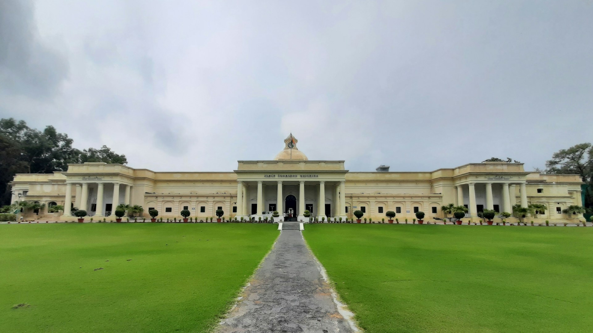A large building with columns and a walkway leading to it