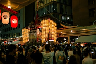 A crowd of people standing around a building at night