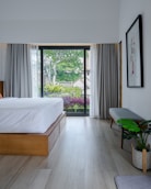 A bedroom with a large bed and a sliding glass door