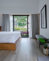 A bedroom with a large bed and a sliding glass door