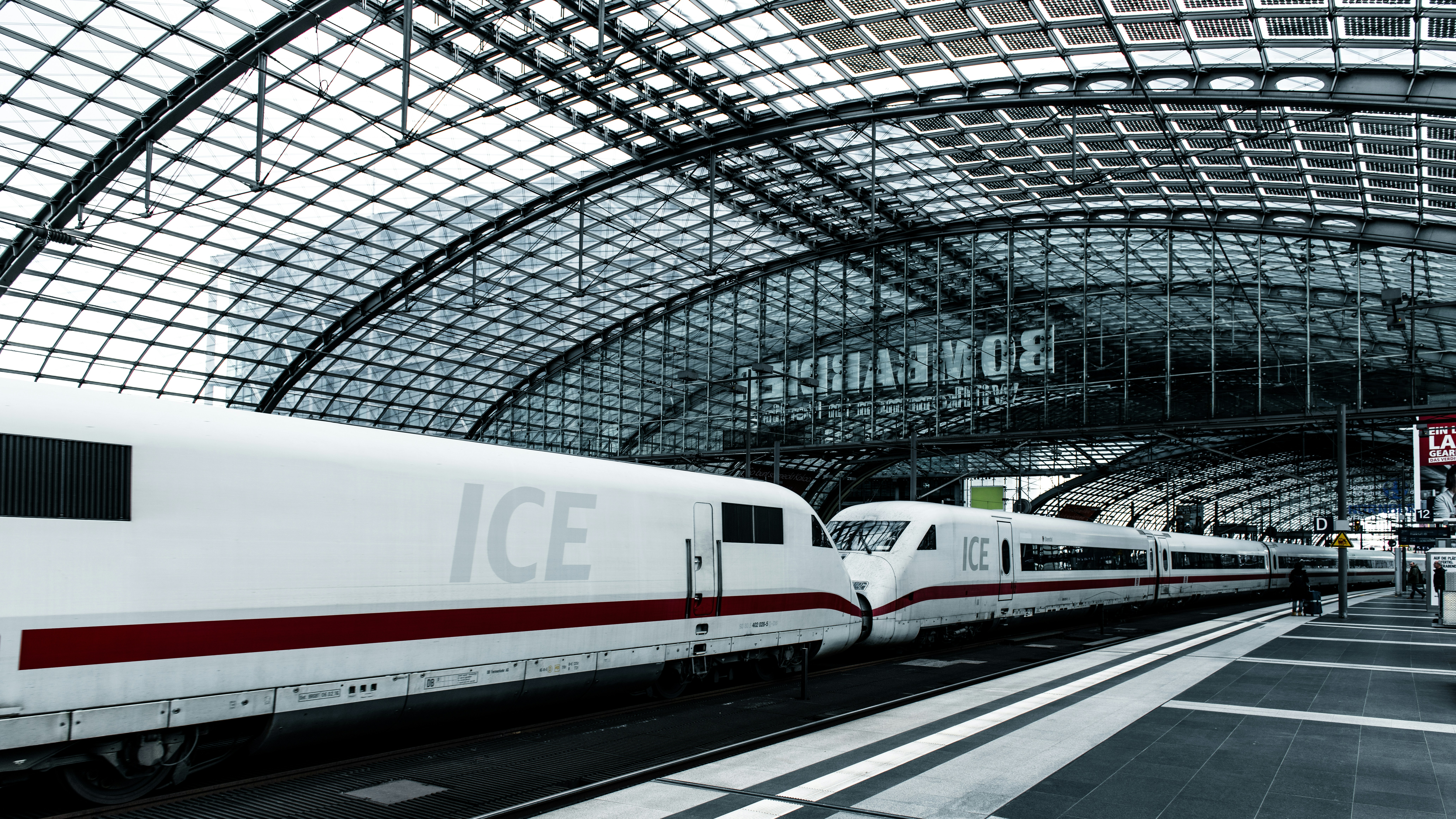 A white and red train traveling through a train station