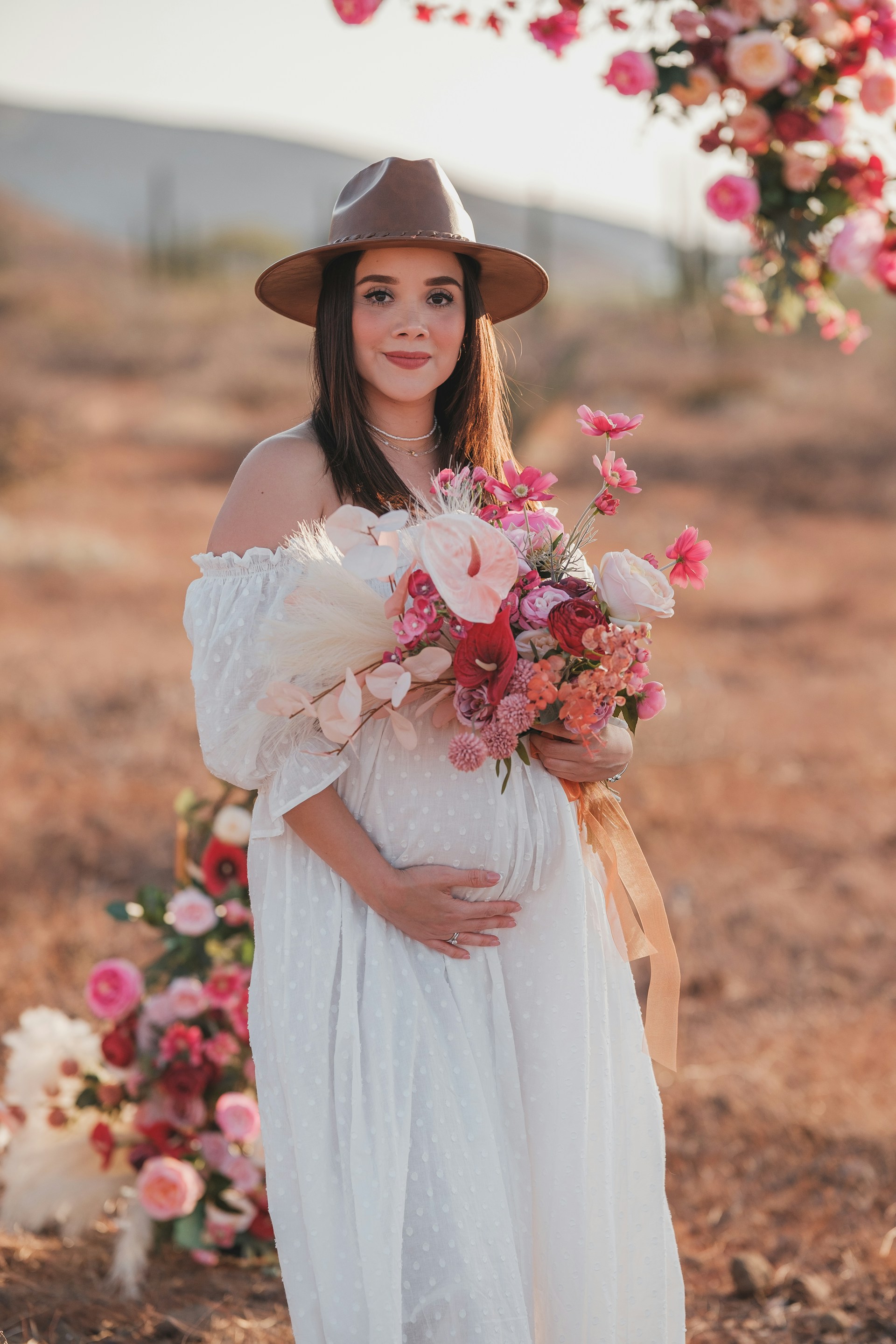 A woman in a white dress holding a bouquet of flowers