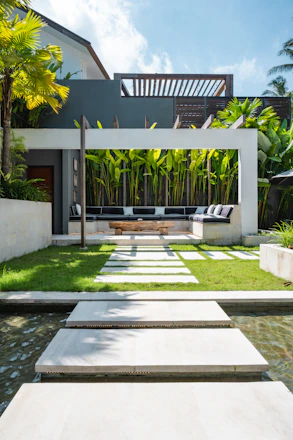 A modern house with a pool in front of it