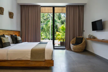 A bedroom with a large bed and a flat screen TV