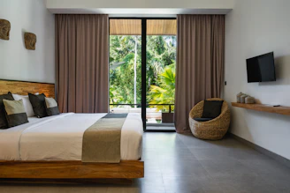 A bedroom with a large bed and a flat screen TV