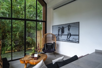 A room with a large window and a wooden table