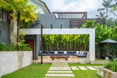 A backyard with a stone path leading to a covered patio