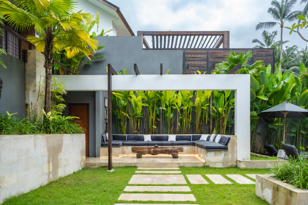 A backyard with a stone path leading to a covered patio