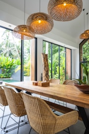 A dining room with a wooden table and chairs