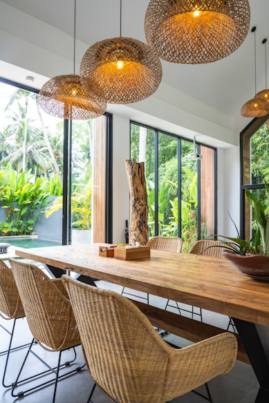 A dining room with a wooden table and chairs
