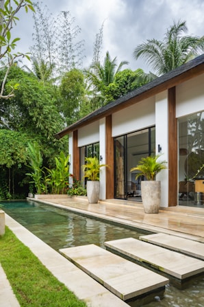 A house with a pool in front of it
