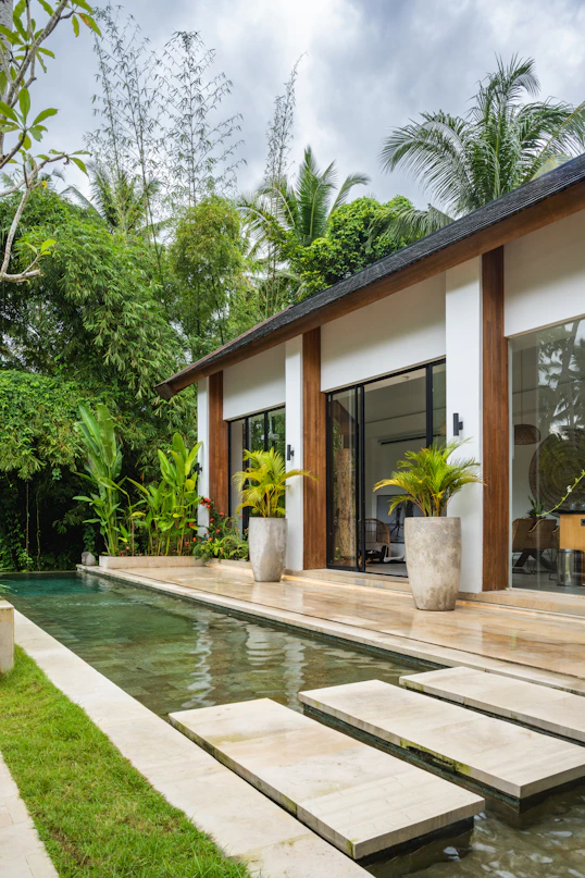 A house with a pool in front of it