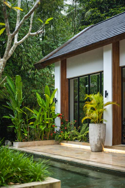 A small house with a pool in front of it