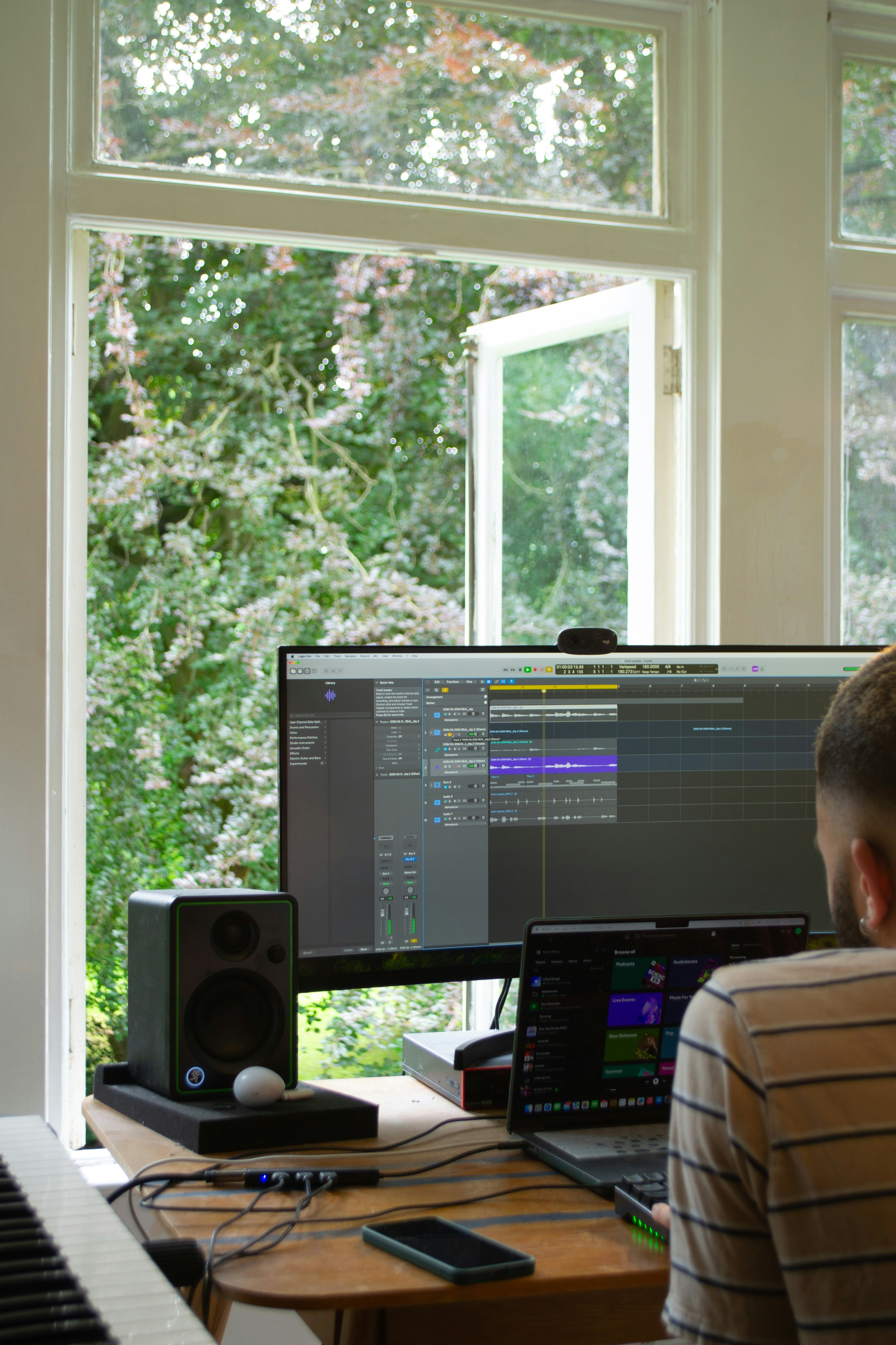 A man sitting in front of a computer on top of a desk