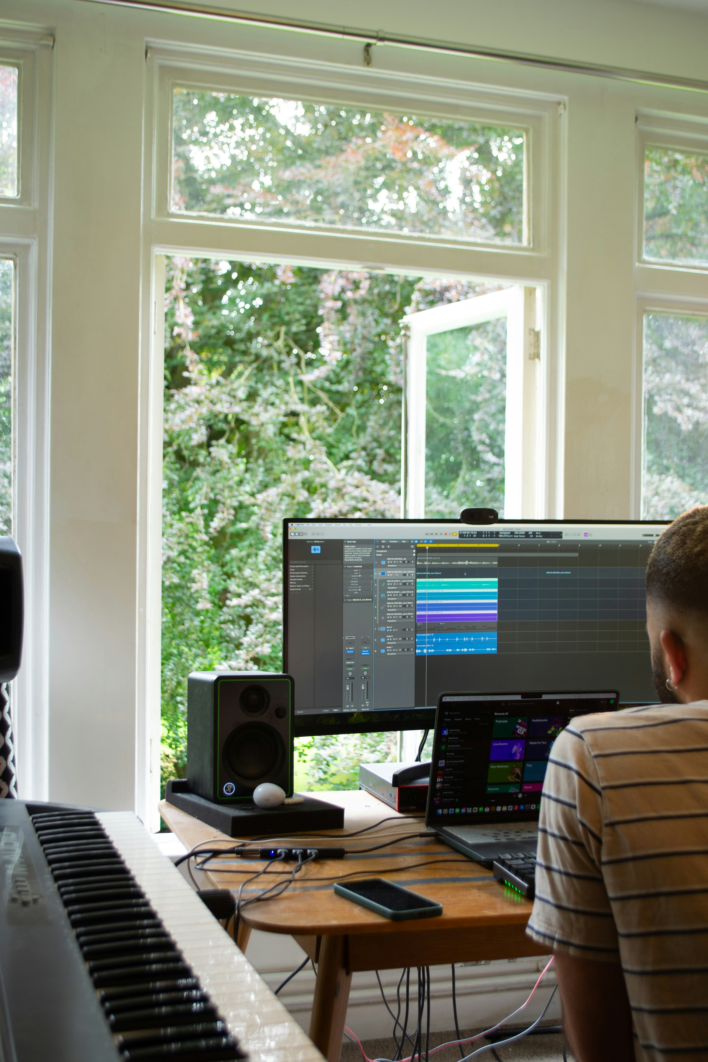A man sitting in front of a computer monitor next to a keyboard
