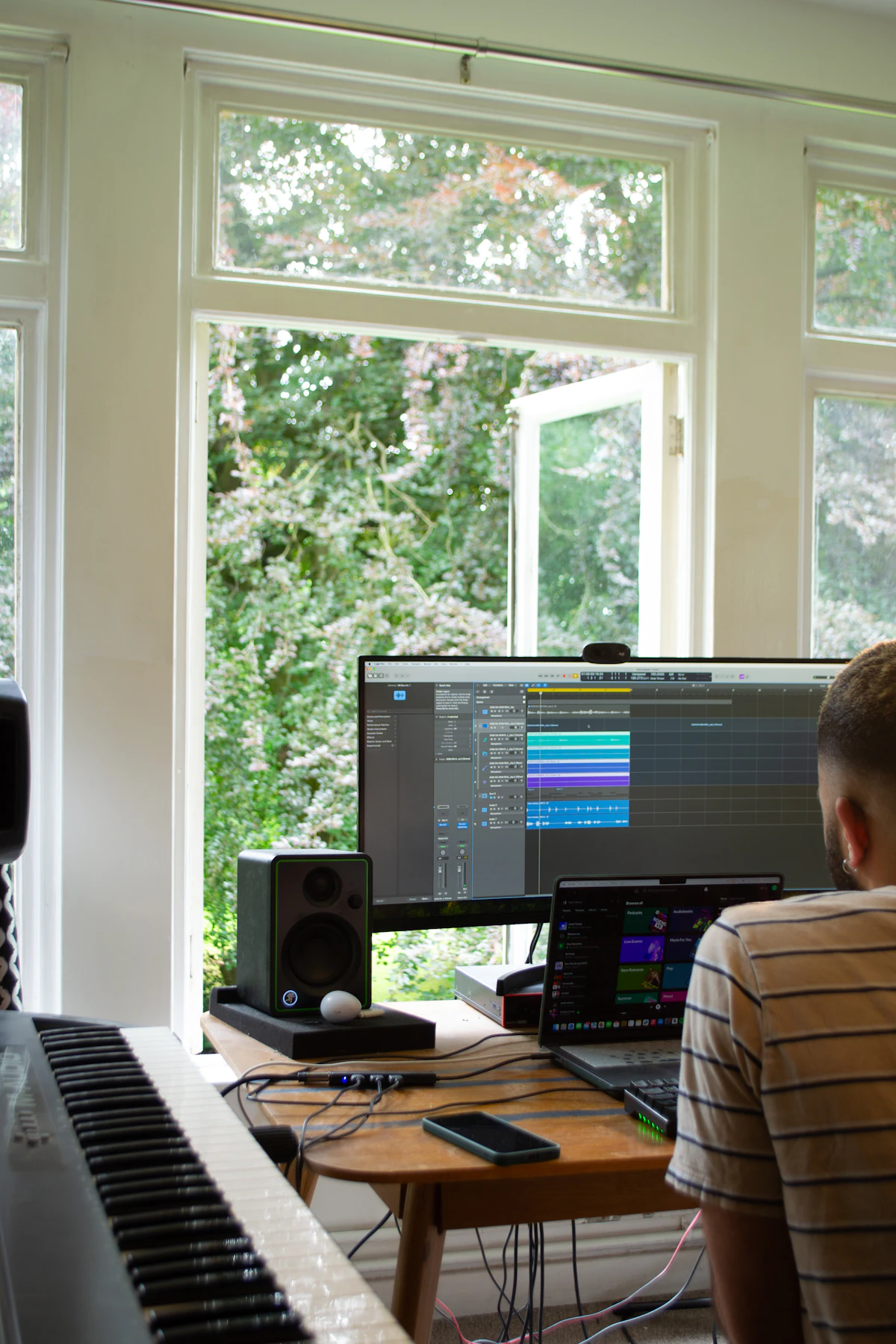 A computer monitor and keyboard on a studio desk