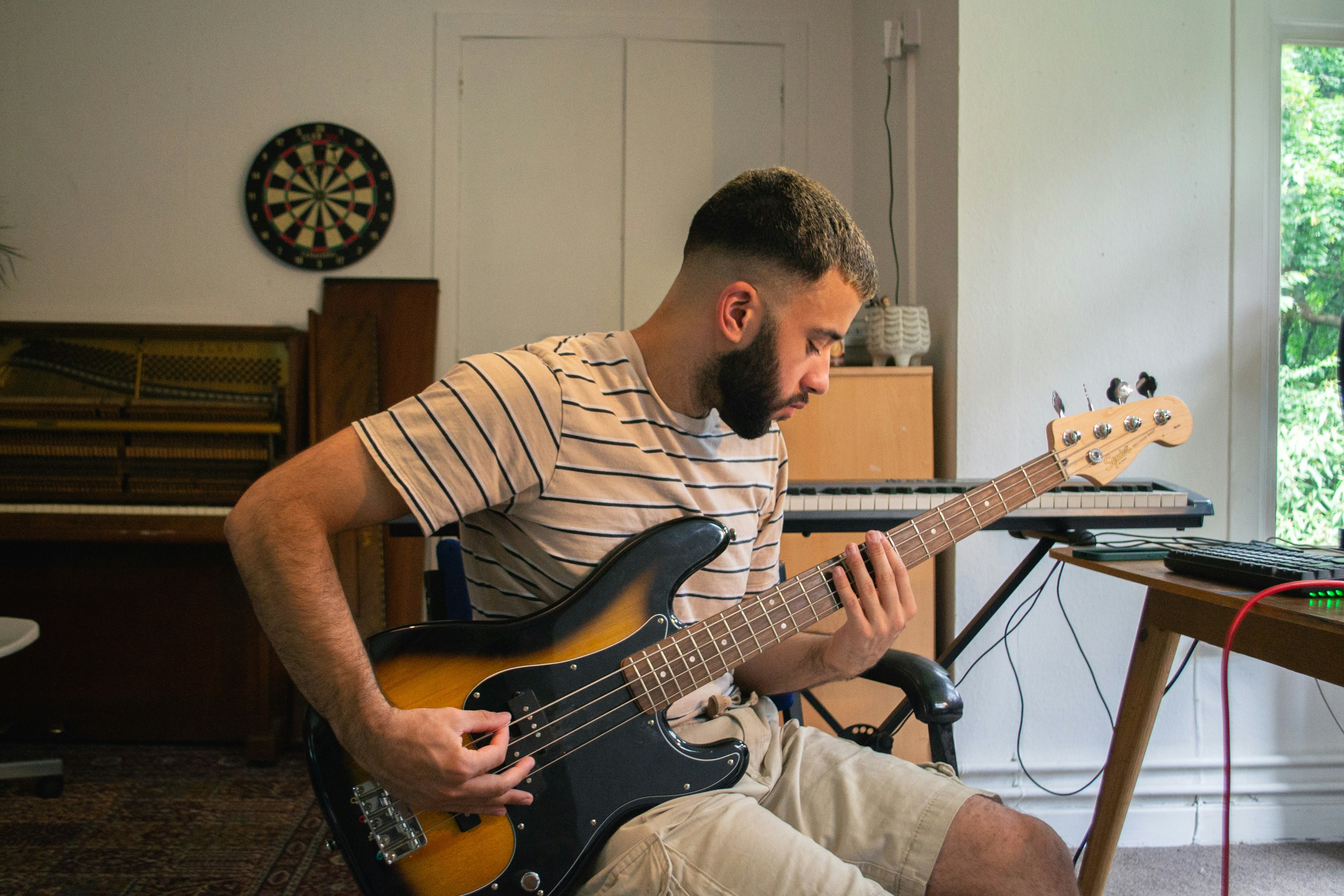 A man playing a guitar in a living room