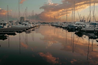 A marina filled with lots of boats under a cloudy sky