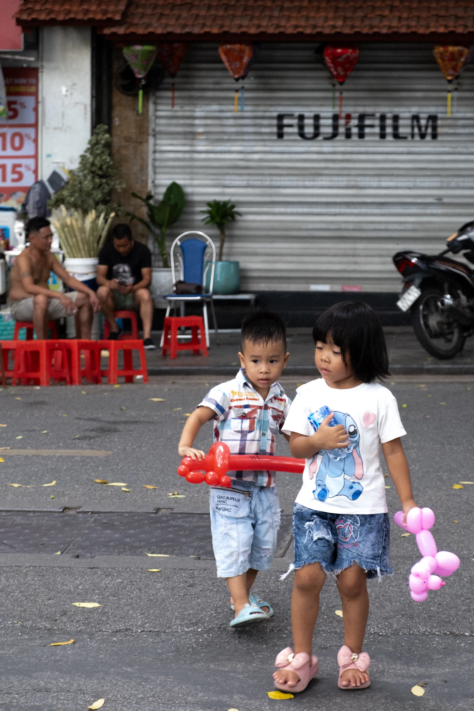 Two children standing in the street