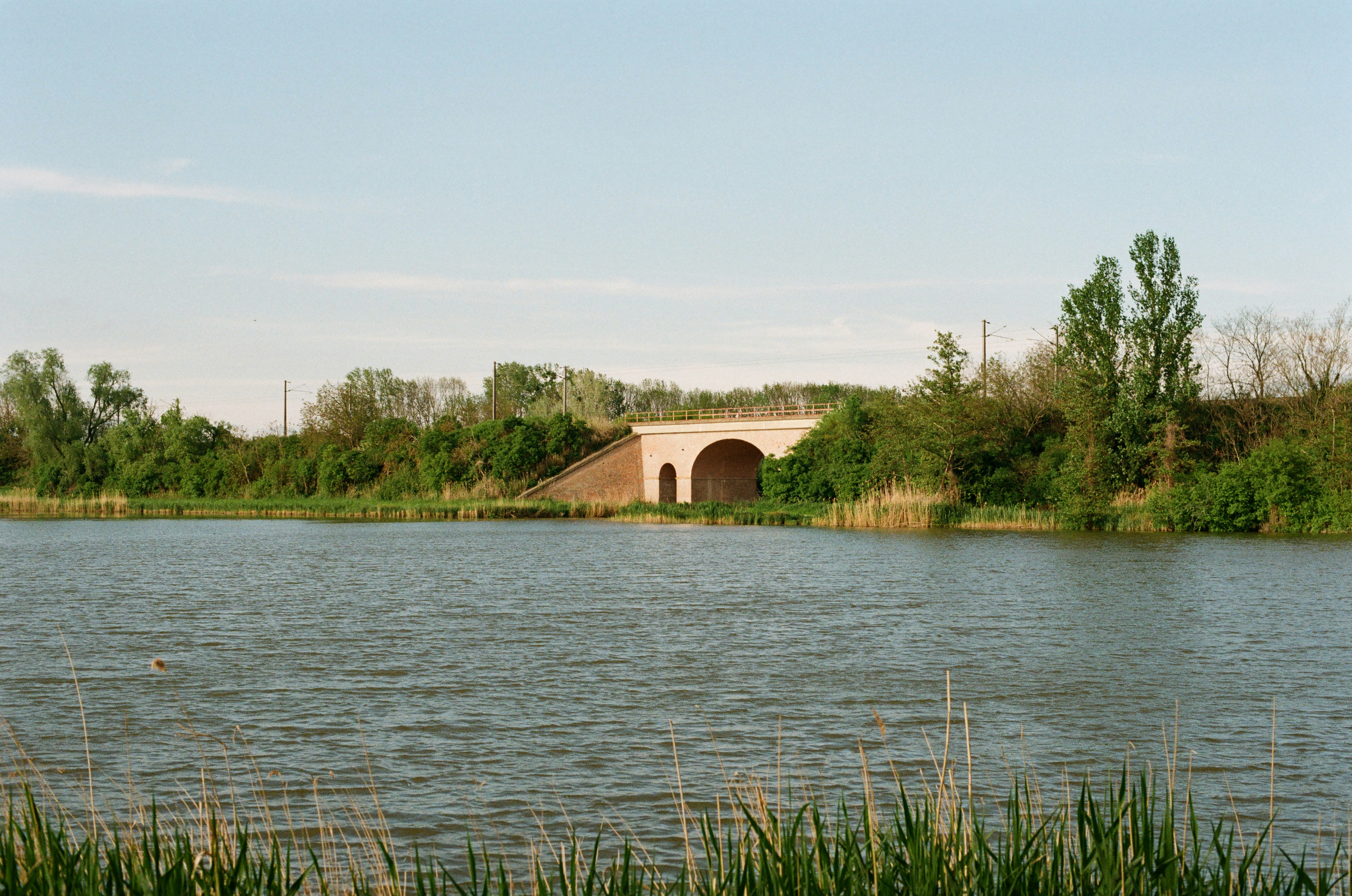 A large body of water with a bridge in the background