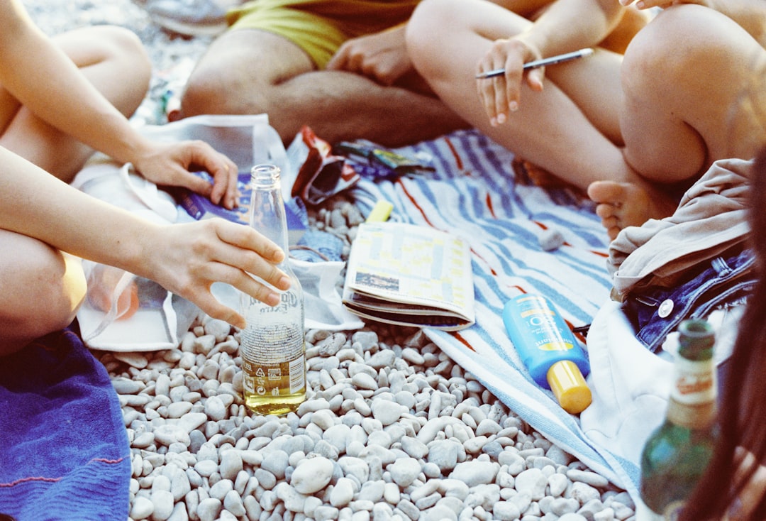 A group of people sitting on a beach next to each other, Photo from Tungsten film roll taken with my AGFA Selectronic 3 