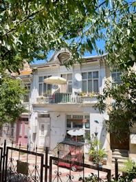 A large white building with a balcony and balconies