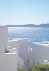 A white building with a view of the ocean