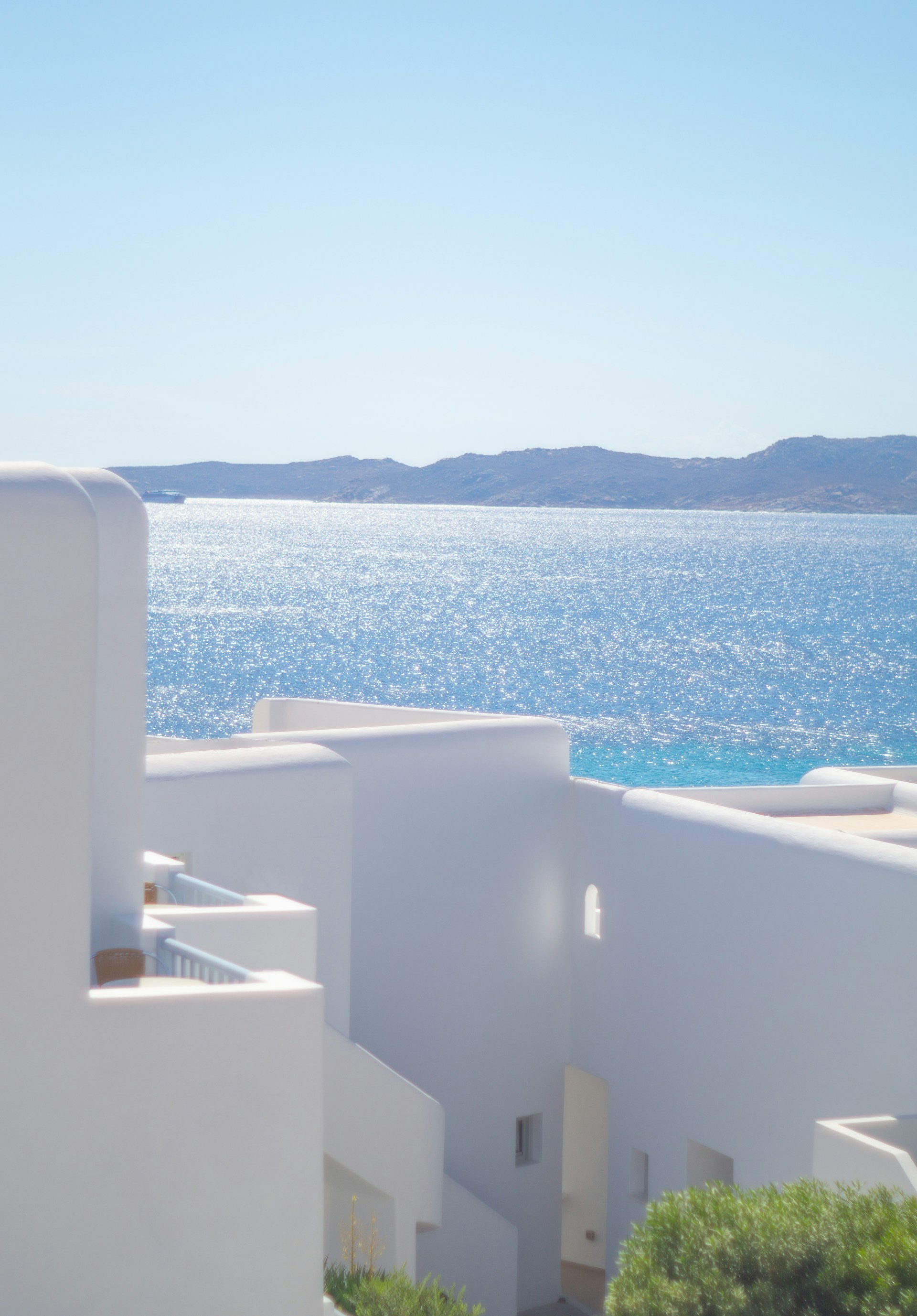 A white building with a view of the ocean