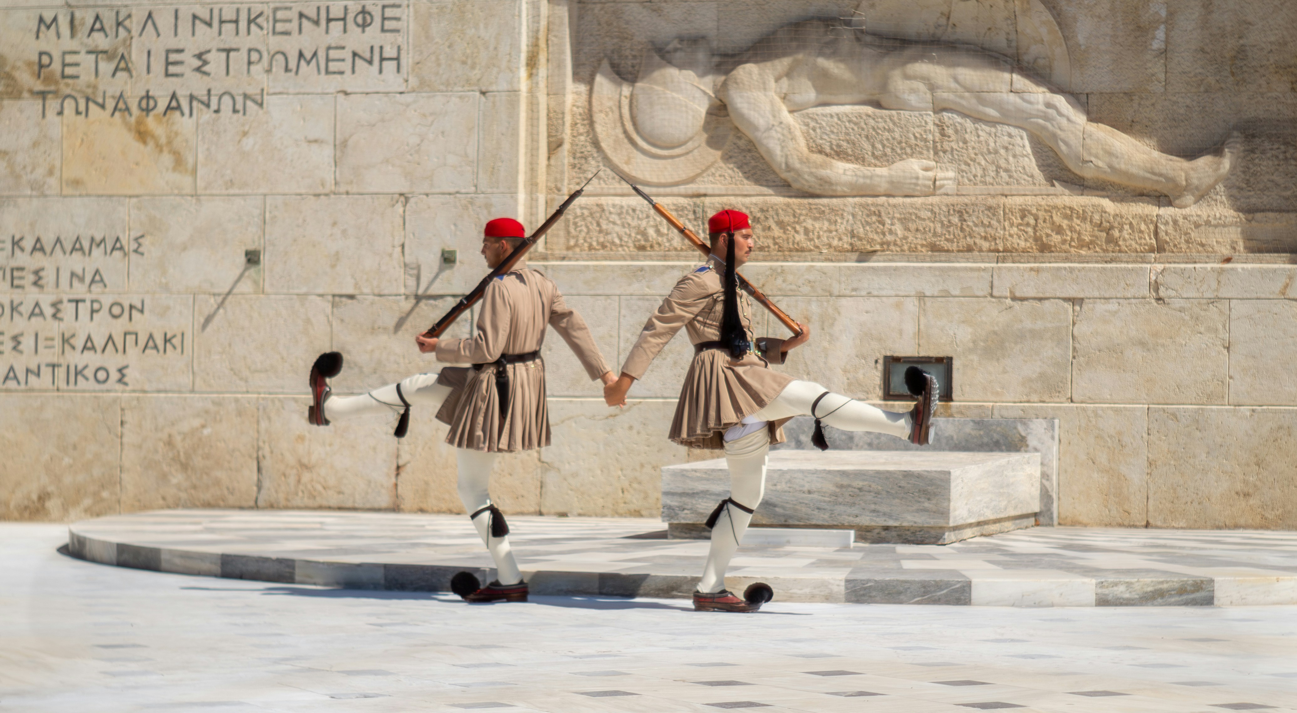 A group of men standing next to each other in front of a monument