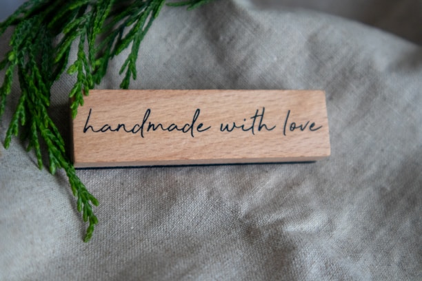 A piece of wood that says handmade with love