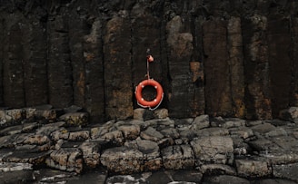 A life preserver hanging on a rock wall