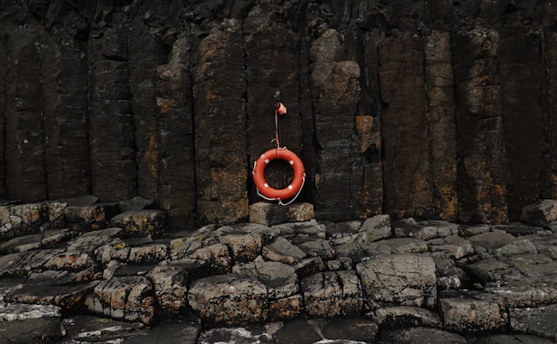 A life preserver hanging on a rock wall