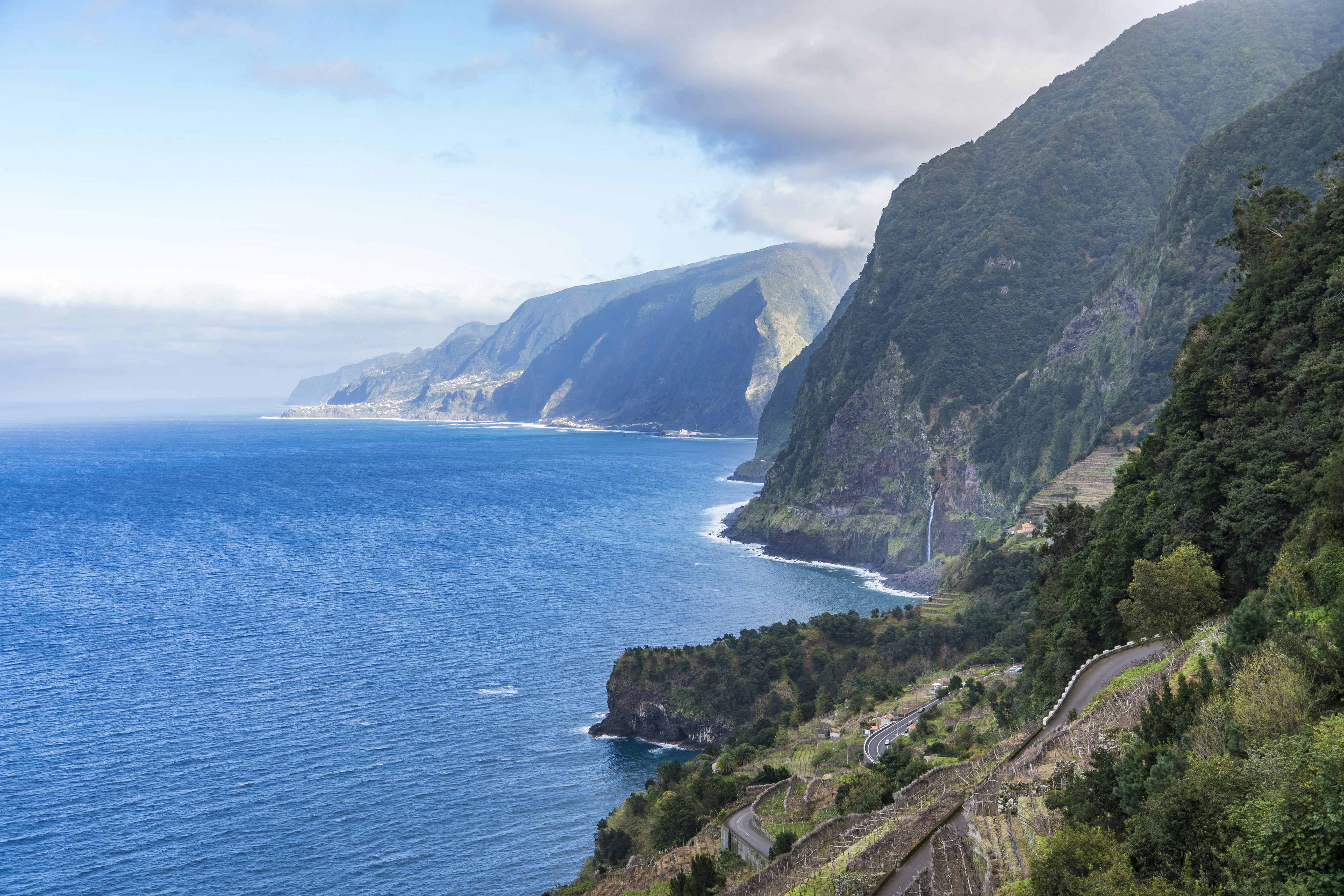 A scenic view of the ocean and mountains