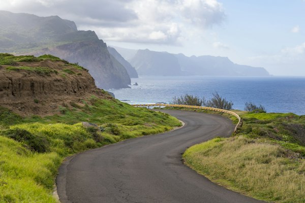 A winding road with a mountain in the background — Madeira, Portugal