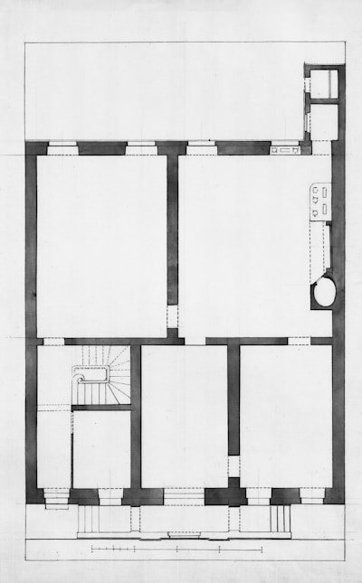 Architectural floor plan of a building with rooms and stairs.