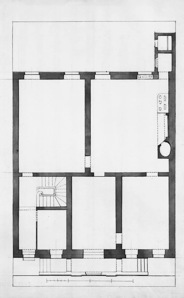 Architectural floor plan of a building with rooms and stairs.