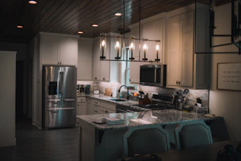 A large kitchen with a center island and a refrigerator